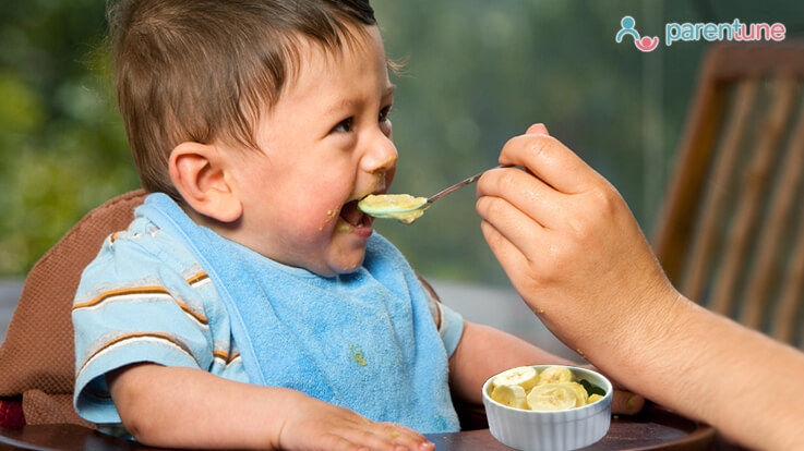 child eating banana